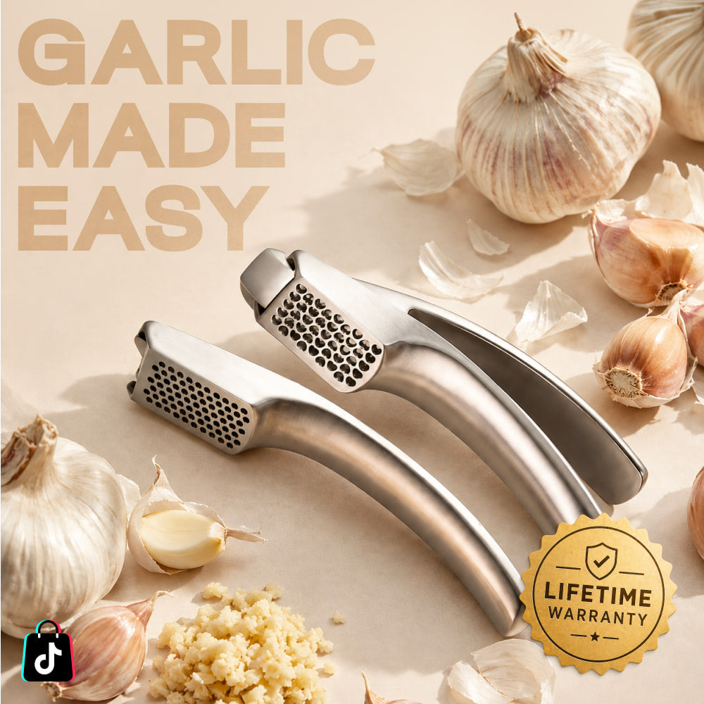Garlic Easy press resting beside whole garlic bulbs and loose cloves