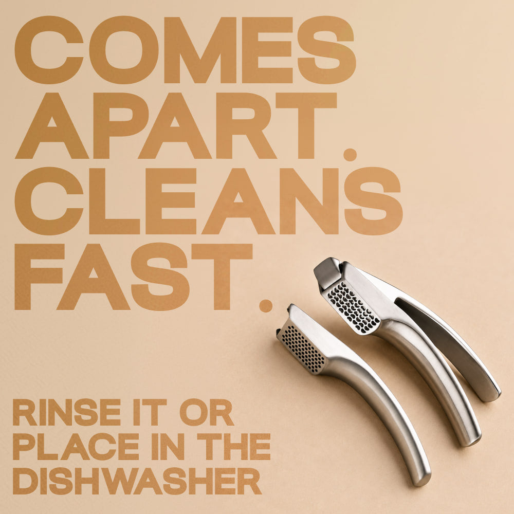 The garlic press taken apart into two pieces for rinsing
