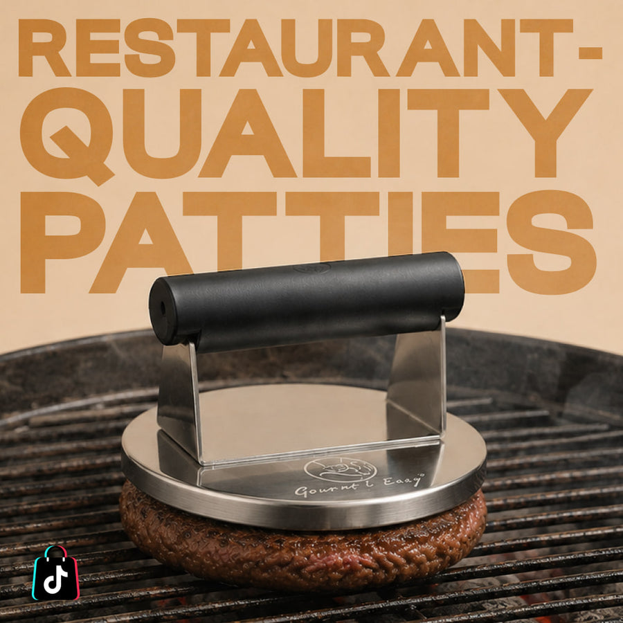 Stainless steel burger press flattening a patty on the grill